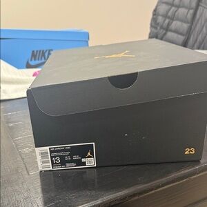 Air Jordan 1 Mid Black and Gold Sneakers